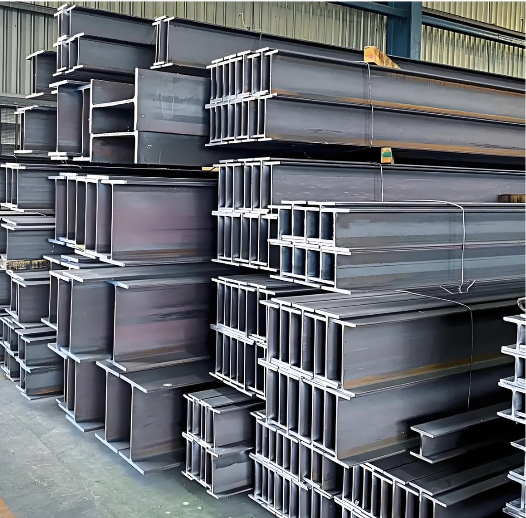 Stacked steel H-beams and I-beams in fabrication factory warehouse